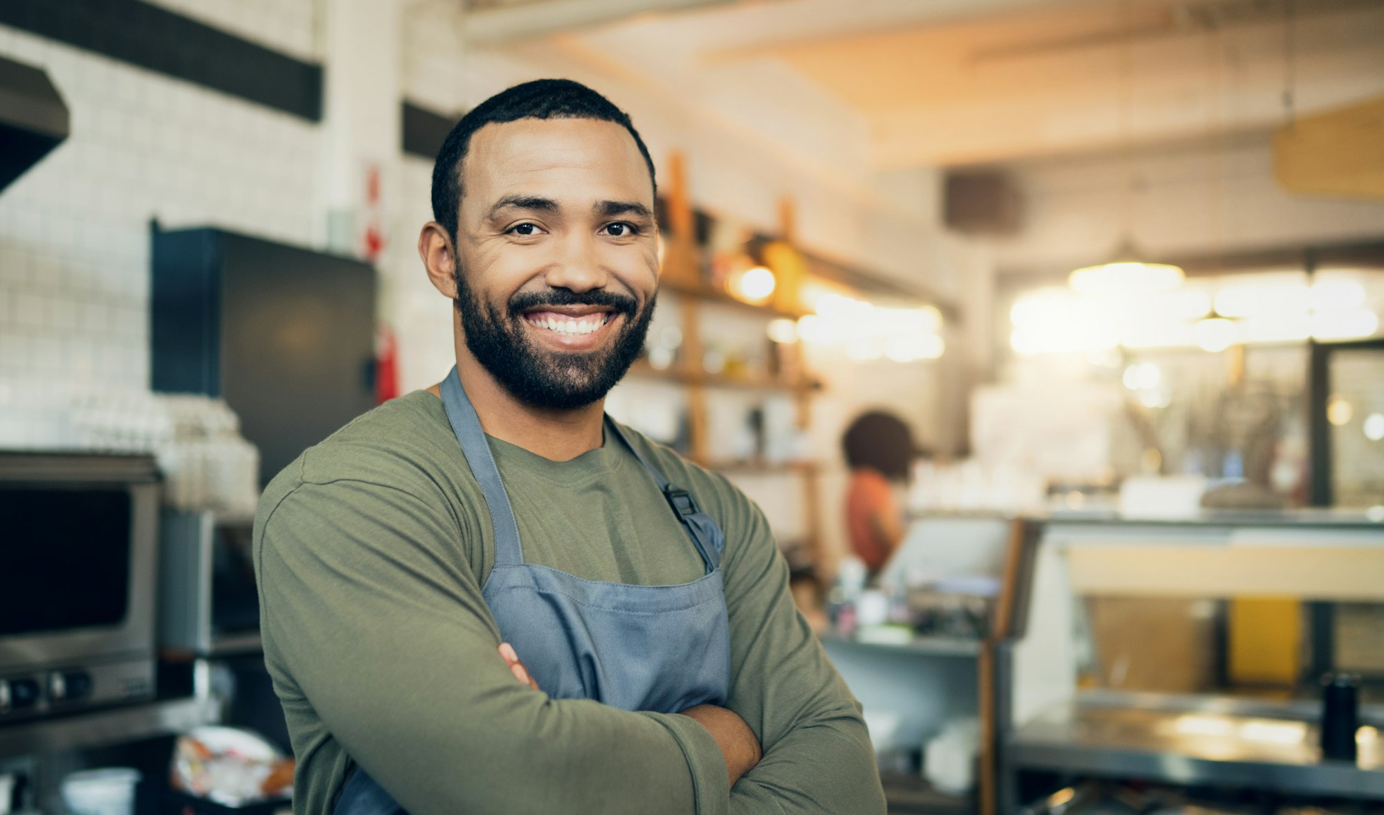 Happy man, portrait and small business owner with arms crossed in kitchen for hospitality service,